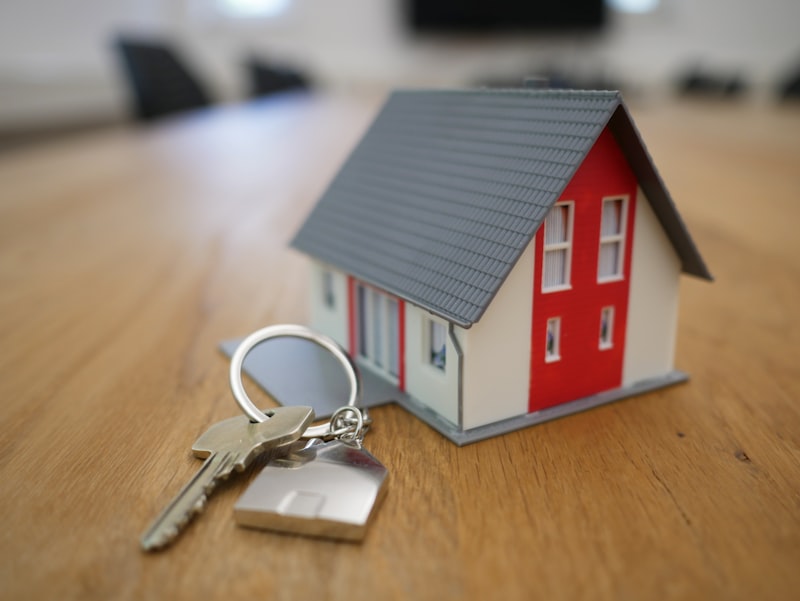 A model house beside a set of keys on a table